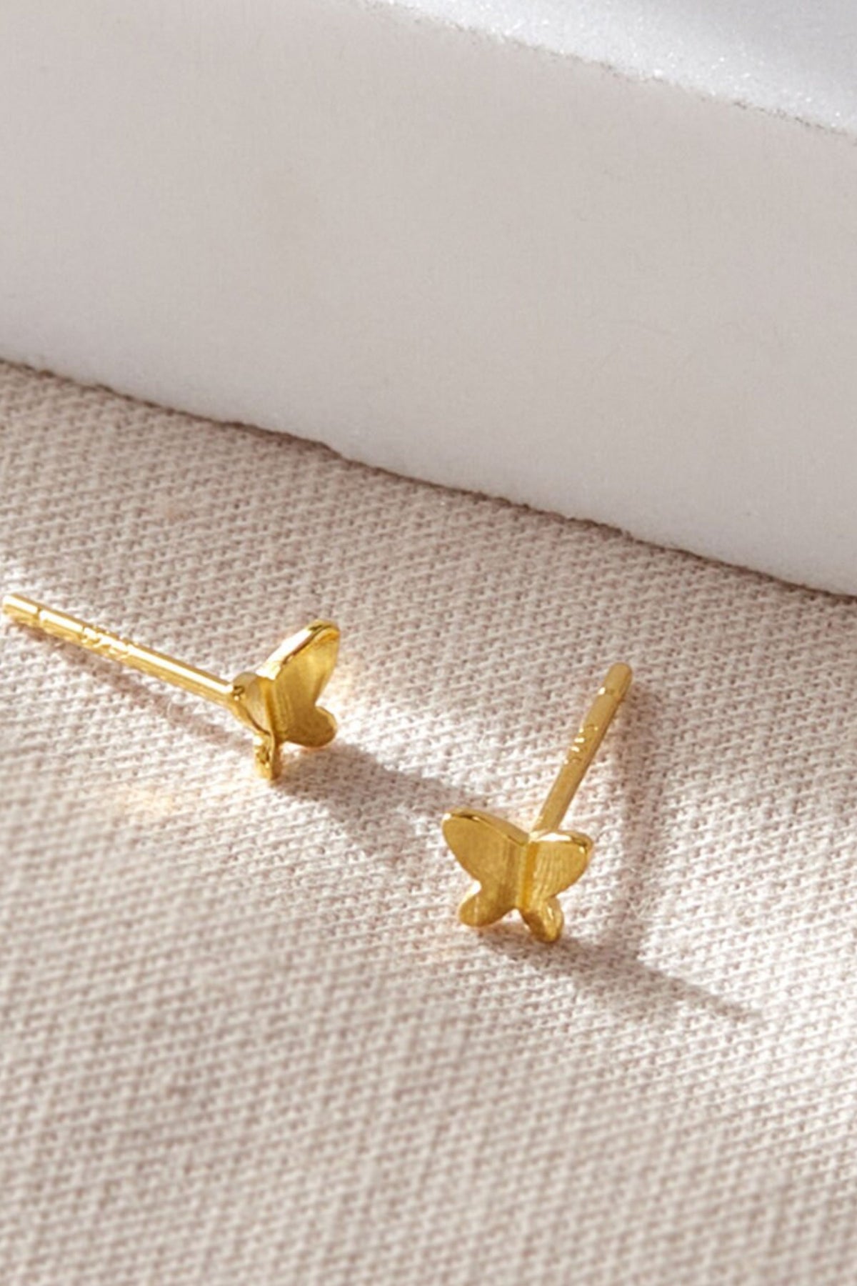 sterling-silver-dainty-butterfly-studs-in-gold-closeup
