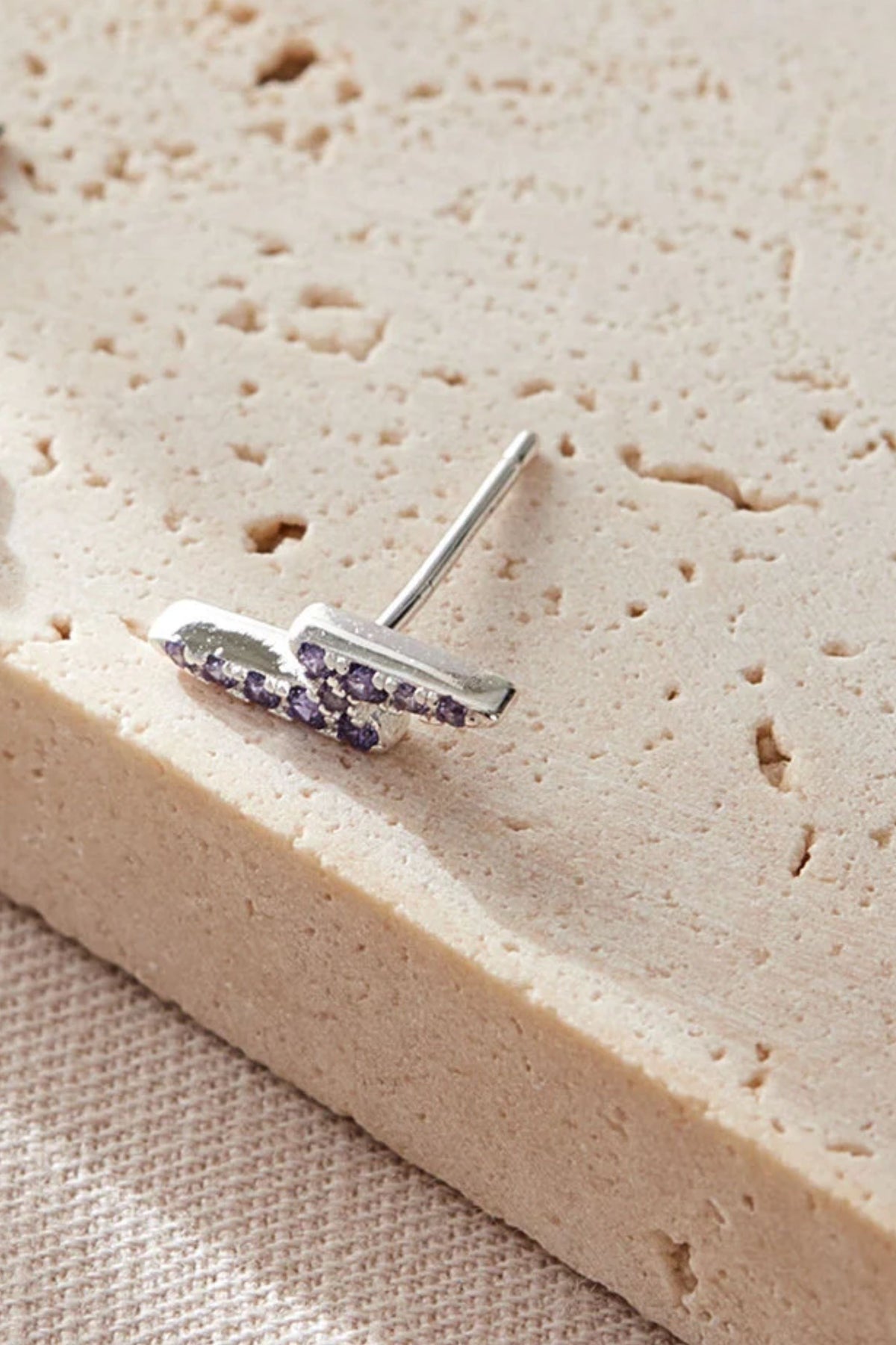 sterling-silver-cz-lightning-bolt-studs-in-silver-purple-closeup