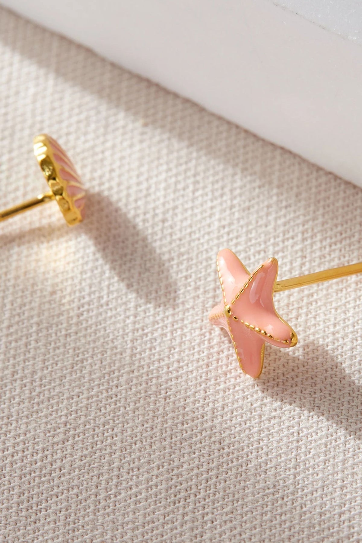 sterling-silver-shell-starfish-studs-in-coral-gold-closeup