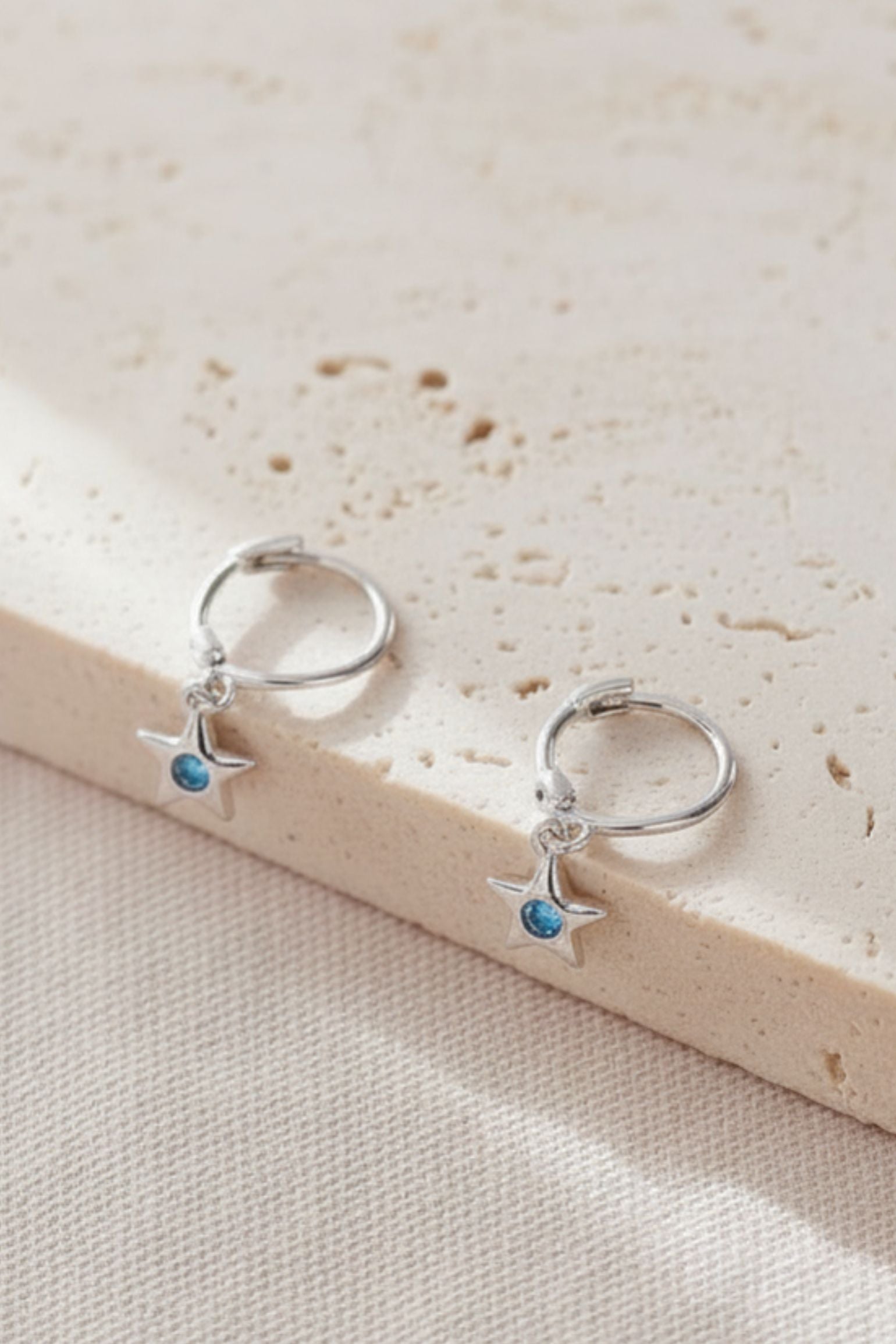 sterling-silver-cz-star-hoops-in-silver-light-blue