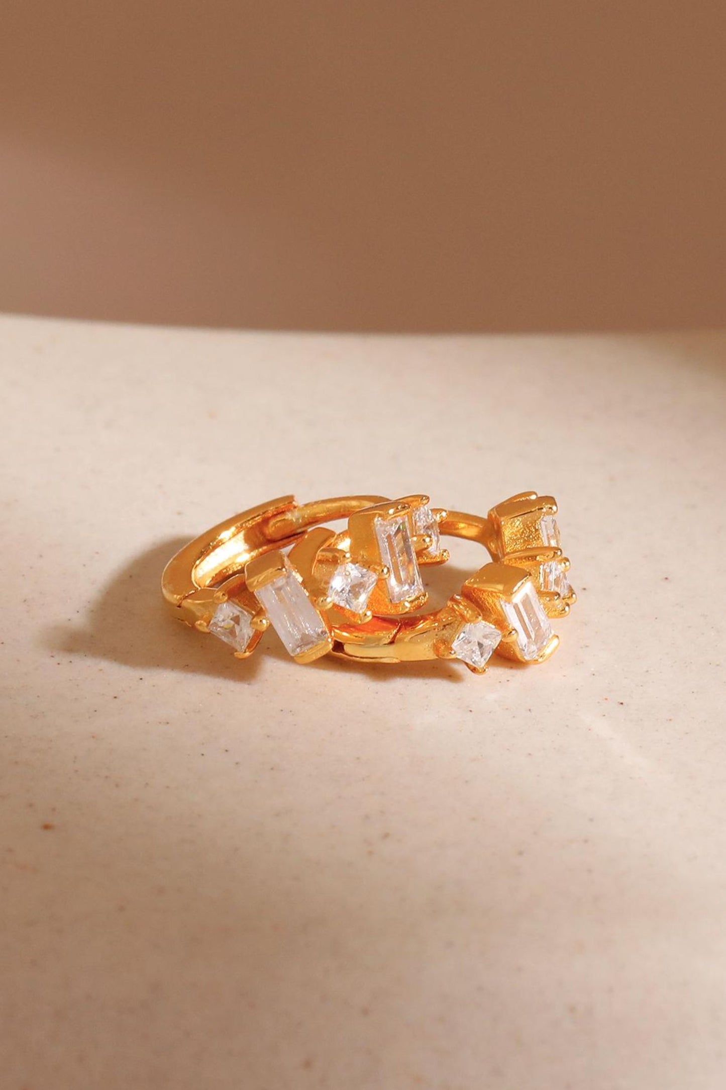sterling-silver-baguette-cz-hoops-in-gold-closeup