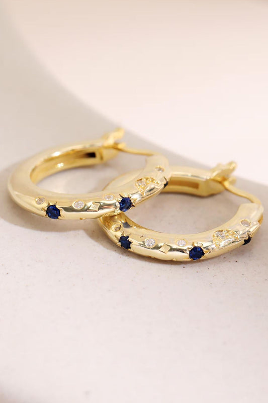 sterling-silver-engraved-celestial-hoops-in-gold-lying-flat
