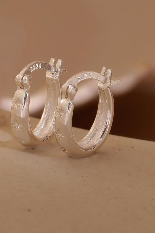 sterling-silver-engraved-starburst-hoops-in-silver-closeup