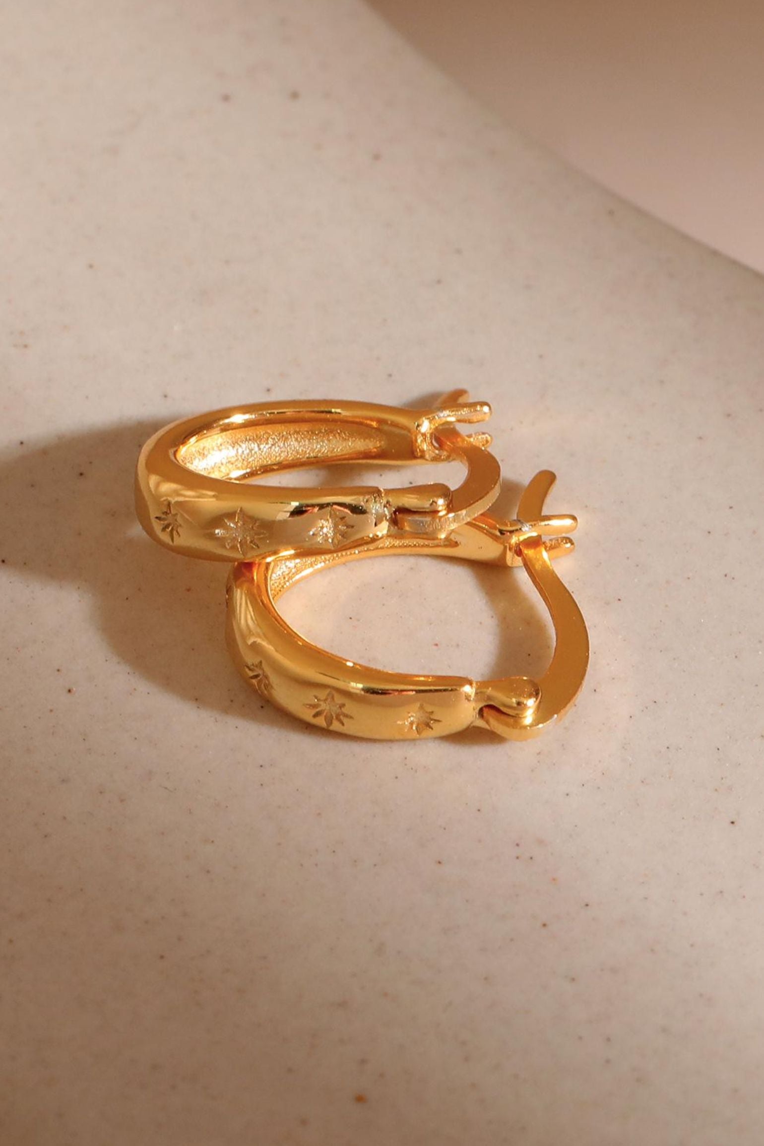 sterling-silver-engraved-starburst-hoops-in-gold-closeup