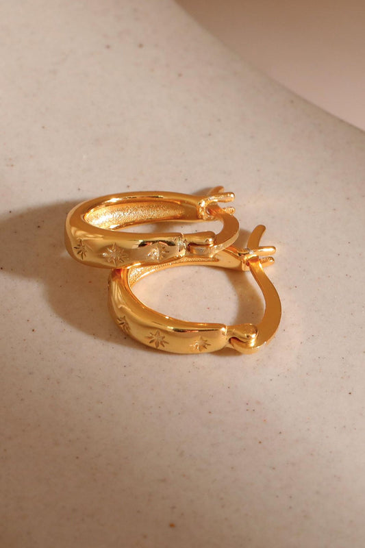 sterling-silver-engraved-starburst-hoops-in-gold-closeup