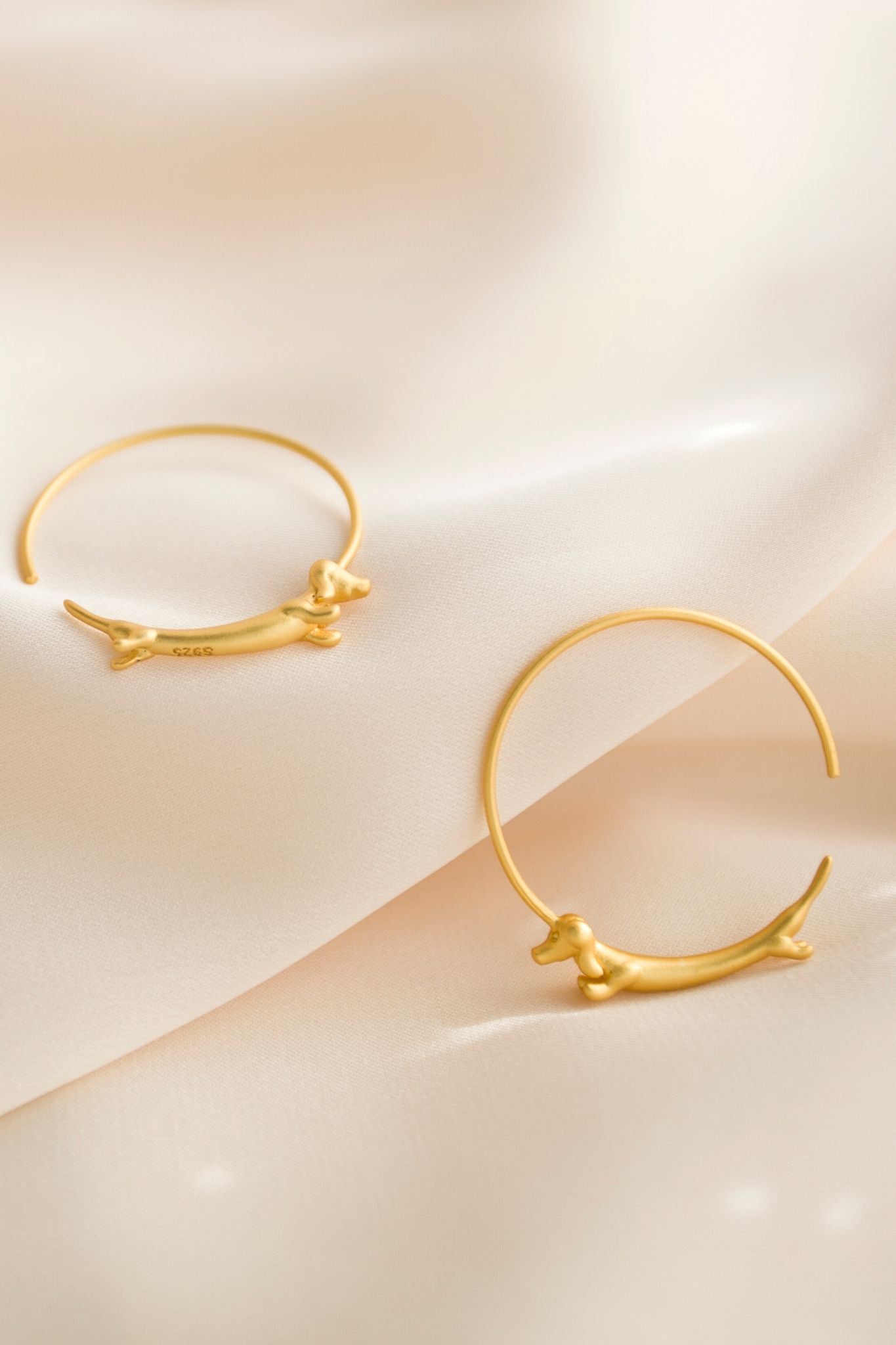 sterling-silver-sausage-dog-hoops-in-gold-closeup