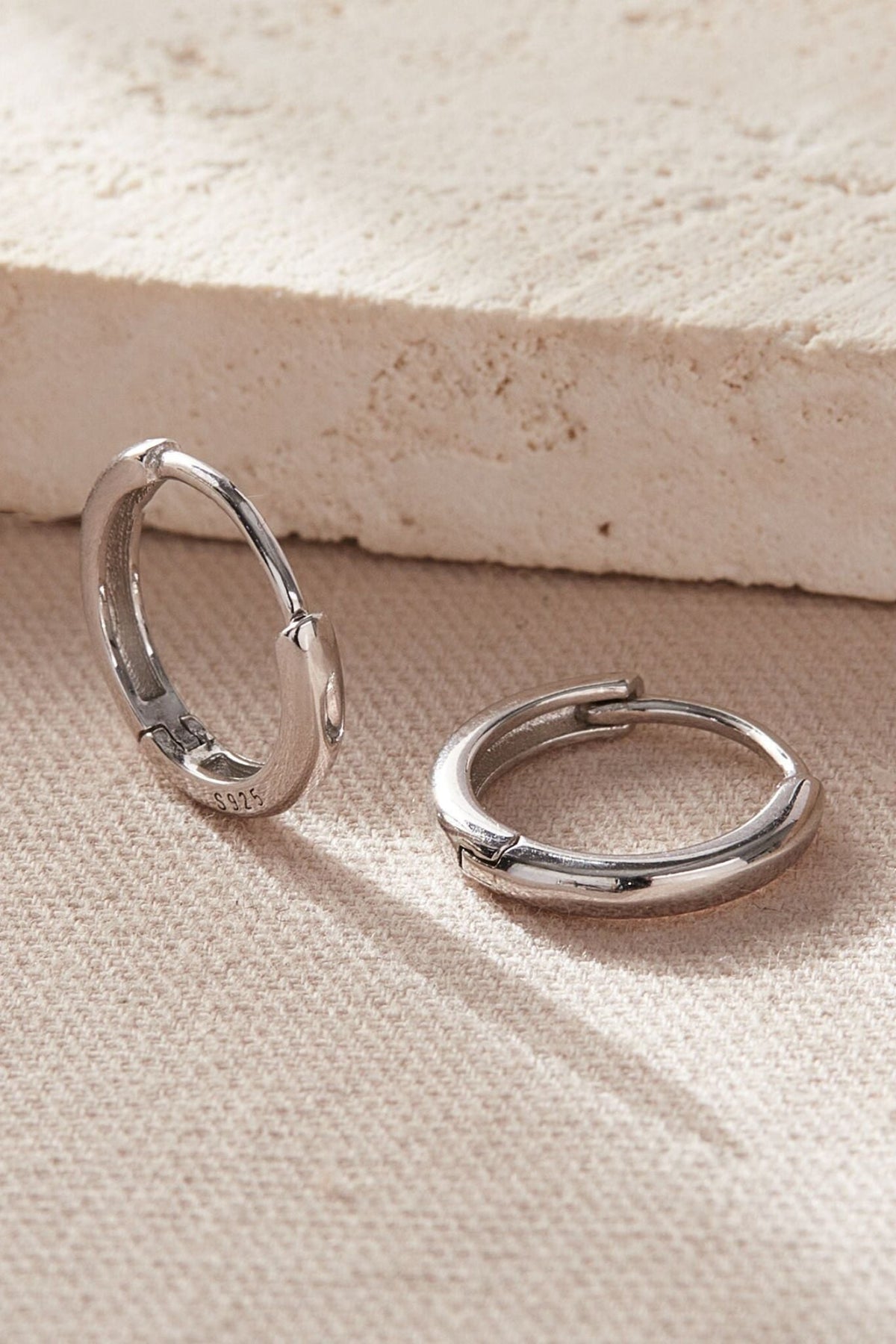 sterling-silver-plain-huggie-hoops-in-silver-various-sizes-closeup