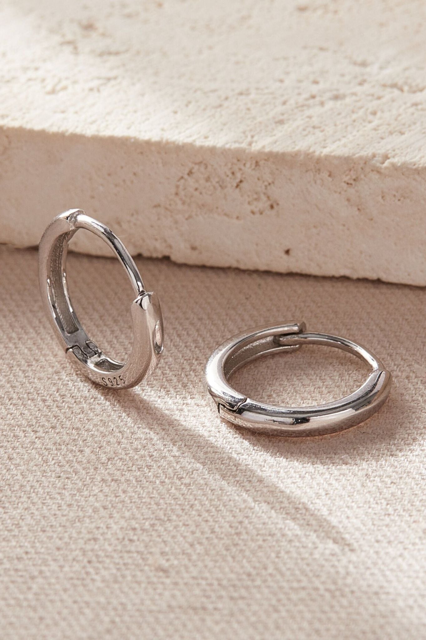 sterling-silver-plain-huggie-hoops-in-silver-various-sizes-closeup