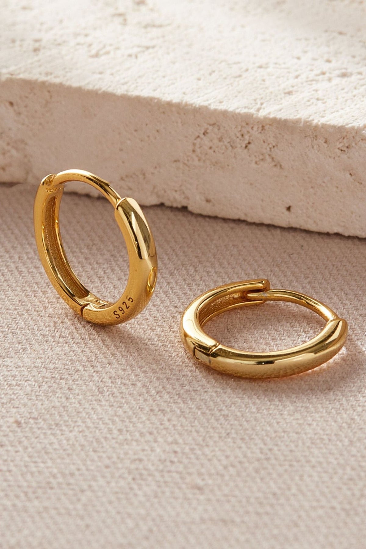 sterling-silver-plain-huggie-hoops-in-gold-various-sizes-closeup