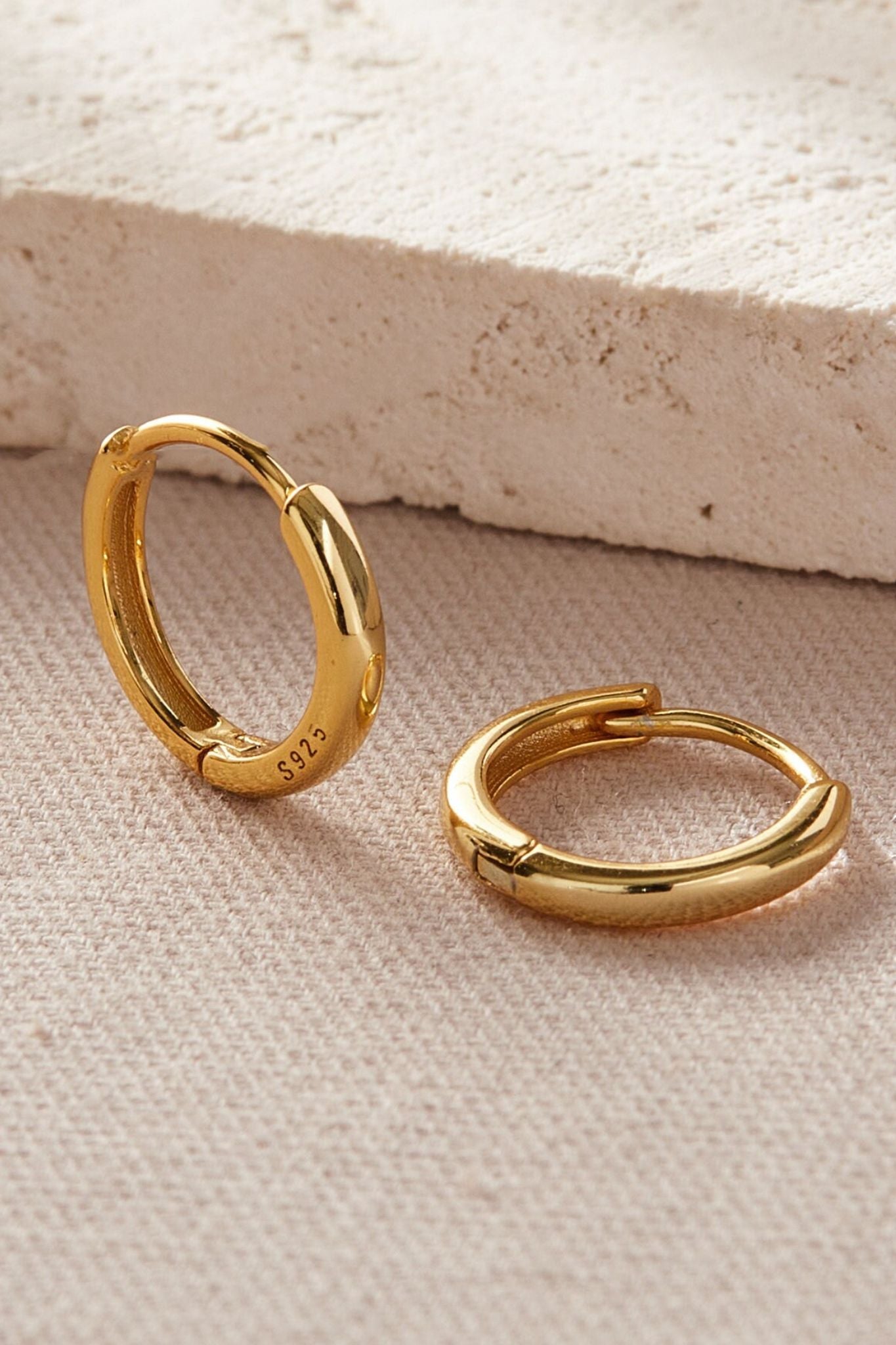 sterling-silver-plain-huggie-hoops-in-gold-various-sizes-closeup
