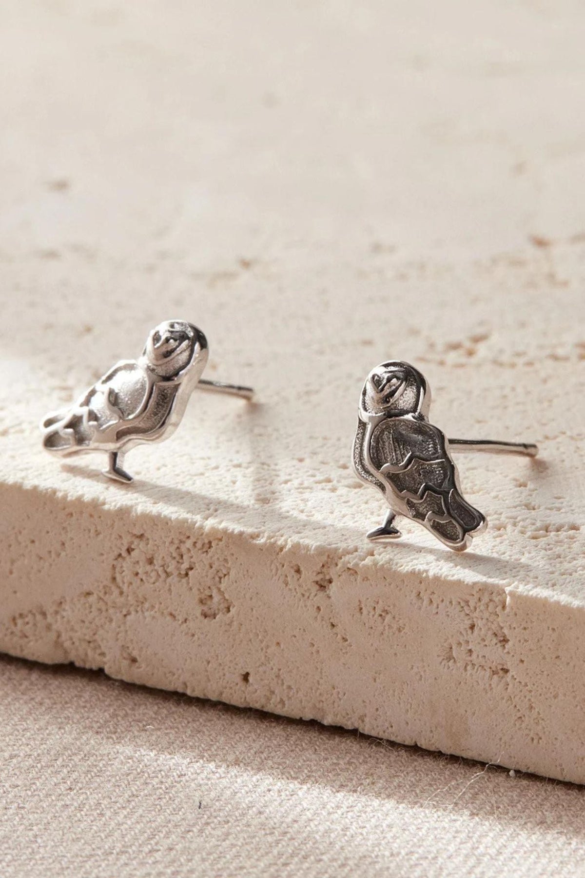 a pair of silver barn owl stud earrings