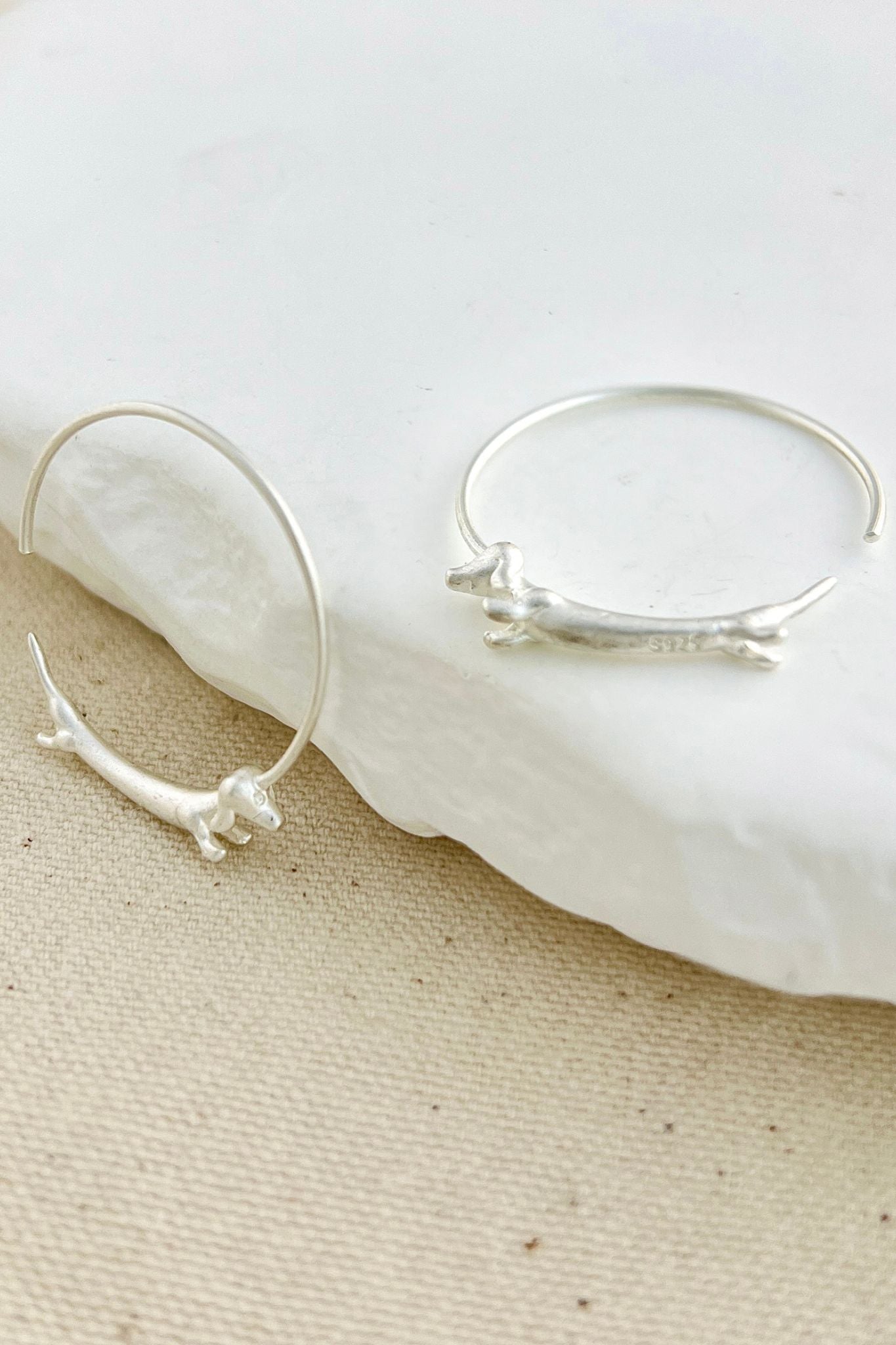 sterling-silver-sausage-dog-hoops-in-silver-closeup