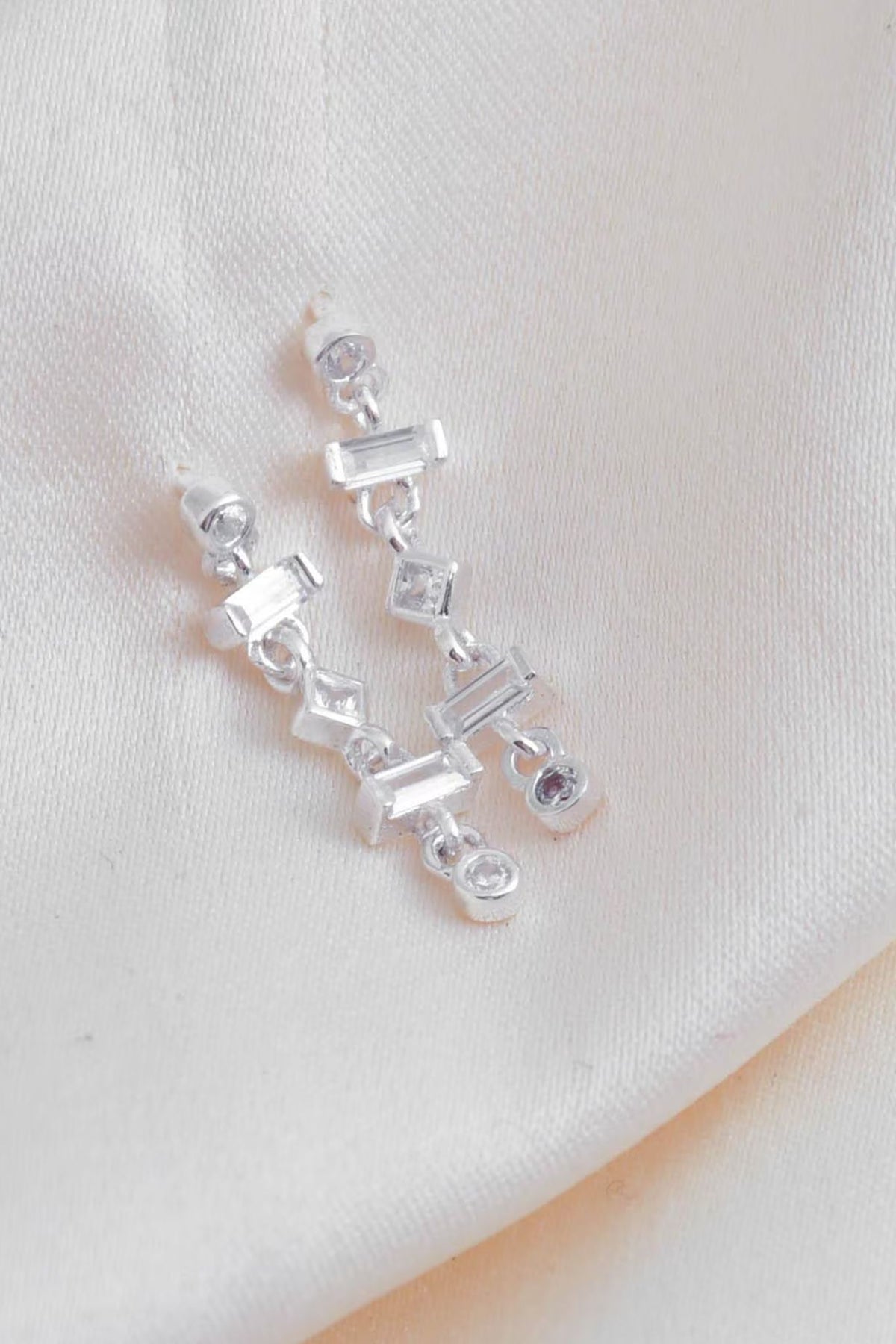 sterling-silver-cz-drop-earrings-lying-flat