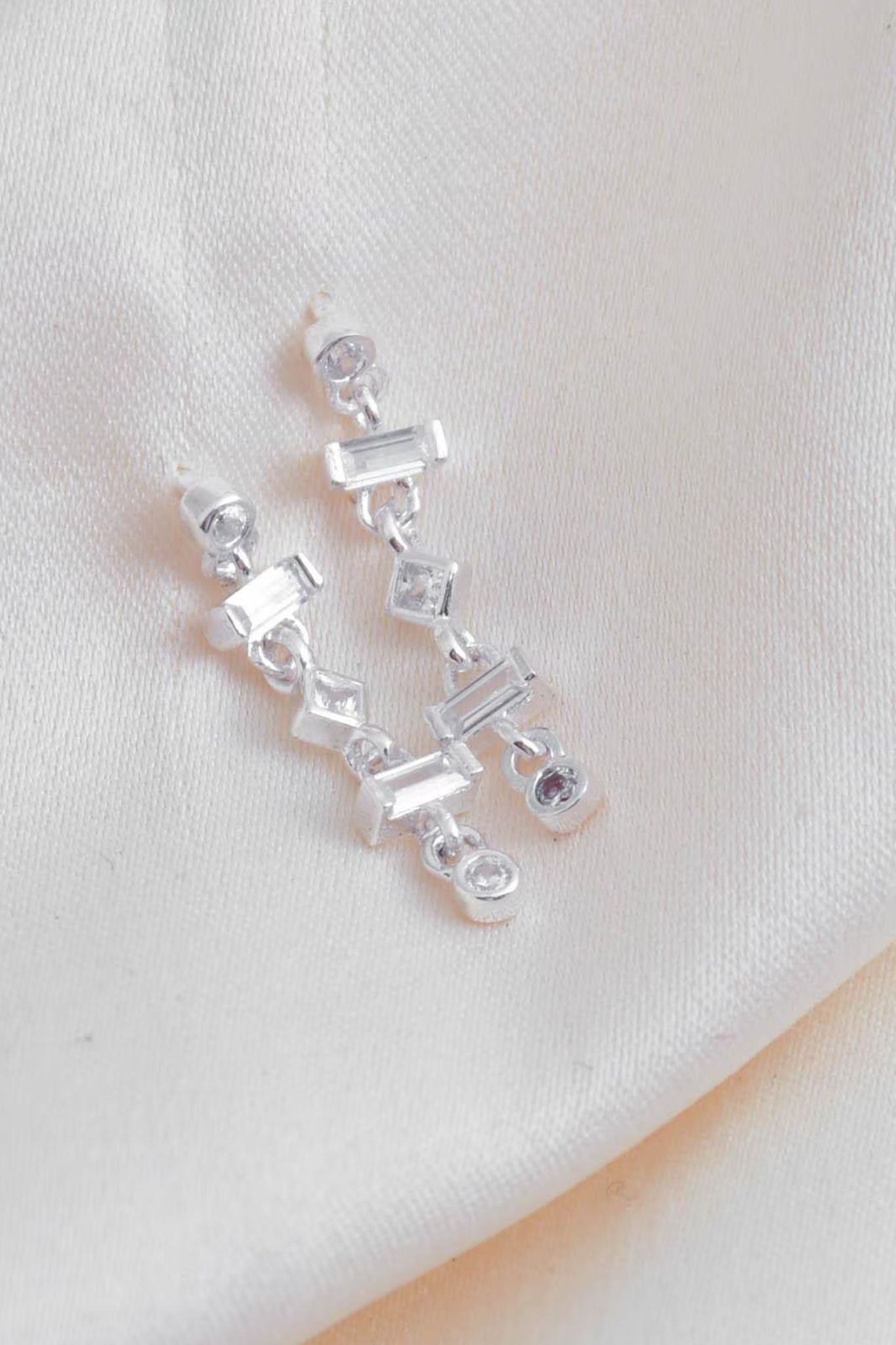 sterling-silver-cz-drop-earrings-lying-flat