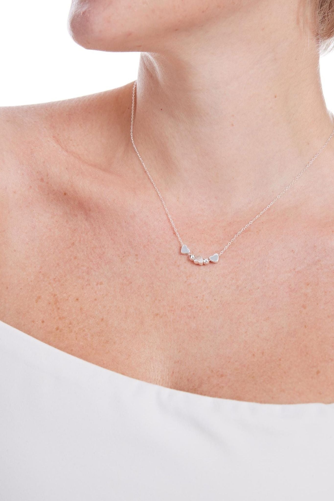 sterling-silver-triple-love-heart-beaded-necklace-model-neckline