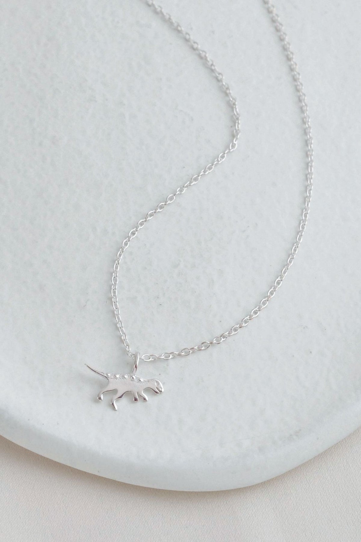 sterling-silver-t-rex-dinosaur-necklace-lying-flat