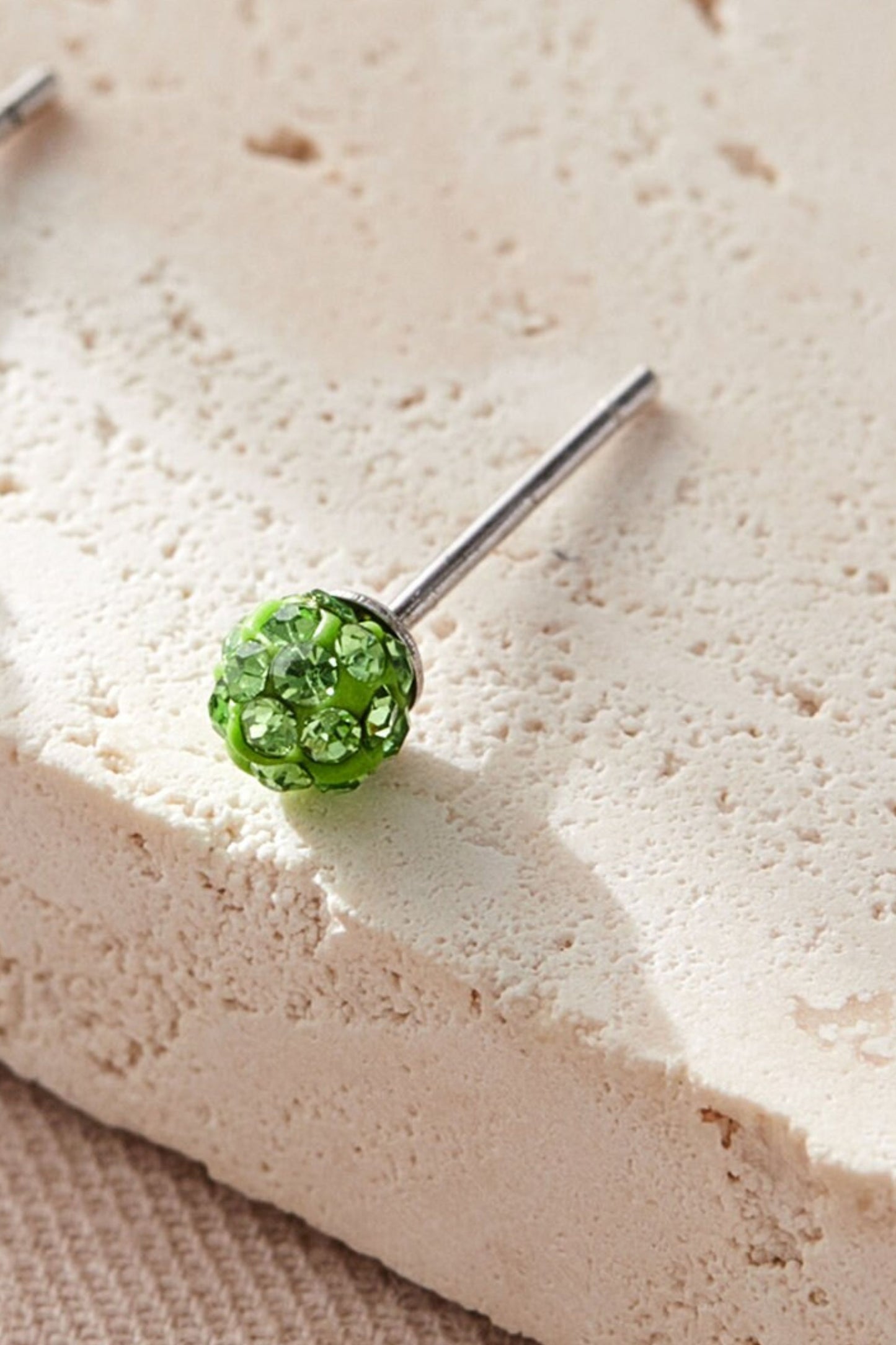 sterling-silver-cz-disco-ball-studs-in-green-closeup